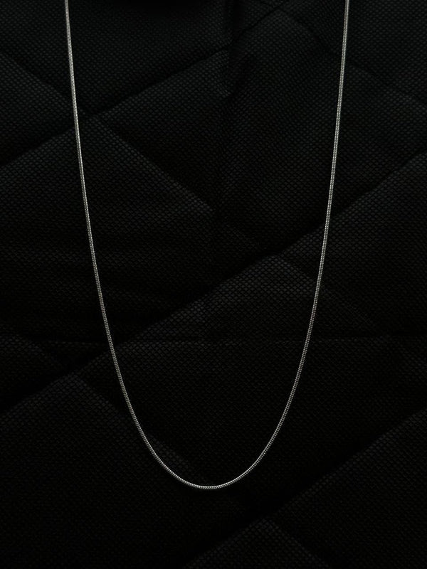 Thin white cable on a textured black background