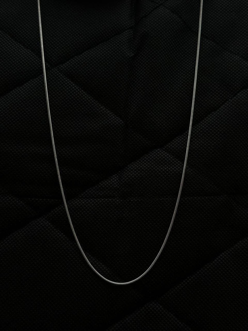 Thin white cable on a textured black background